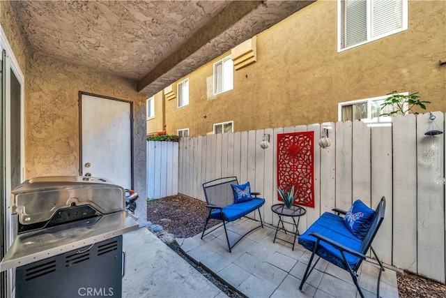 view of patio featuring a grill