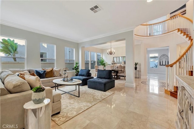 living room with crown molding and a notable chandelier