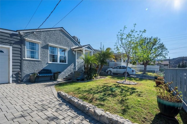 exterior space with a garage and a front lawn