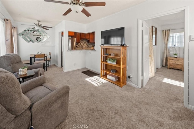 living room featuring light carpet and ceiling fan