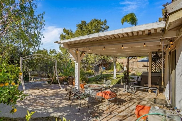 view of patio / terrace featuring an outdoor fire pit, a hot tub, and a pergola