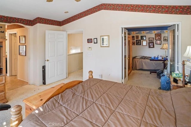 bedroom featuring vaulted ceiling, ceiling fan, and carpet