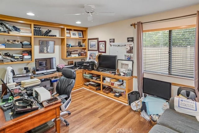 office with ceiling fan and light hardwood / wood-style flooring