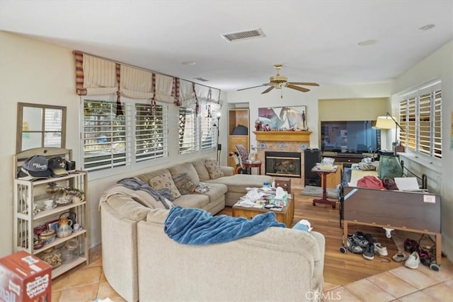 living room with ceiling fan and light tile patterned flooring