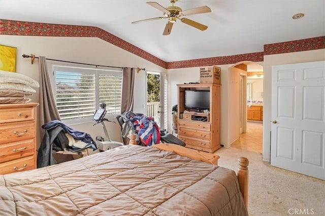 carpeted bedroom with vaulted ceiling, ensuite bath, and ceiling fan