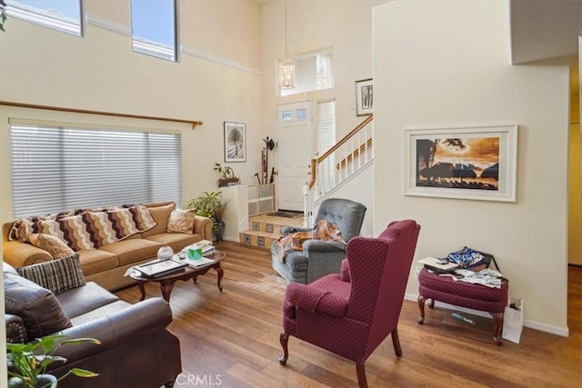 living room featuring a high ceiling and hardwood / wood-style flooring