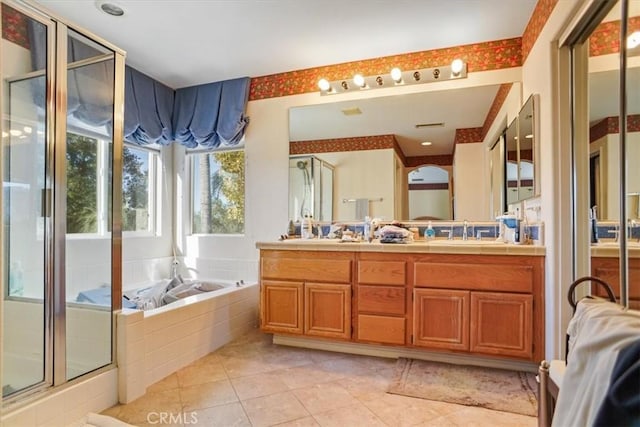 bathroom featuring tile patterned flooring, shower with separate bathtub, and vanity