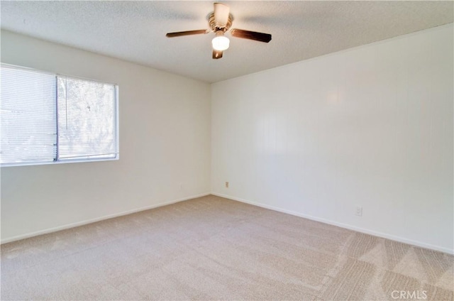 spare room featuring ceiling fan and light colored carpet