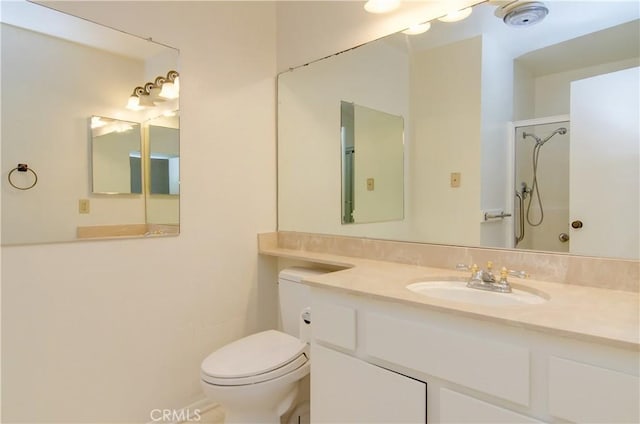 bathroom with toilet, walk in shower, and vanity