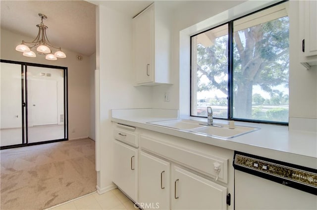 kitchen with light tile patterned floors, white cabinetry, white dishwasher, pendant lighting, and sink