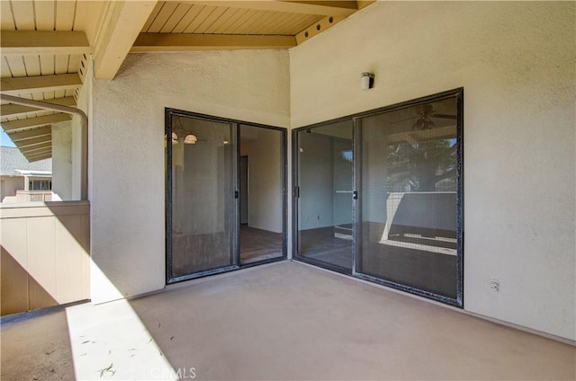 view of exterior entry with a patio area