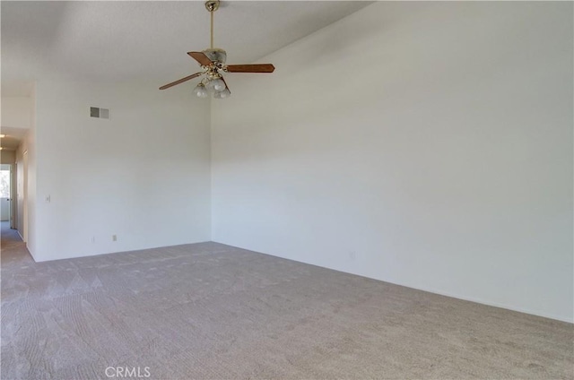 carpeted empty room featuring ceiling fan and vaulted ceiling