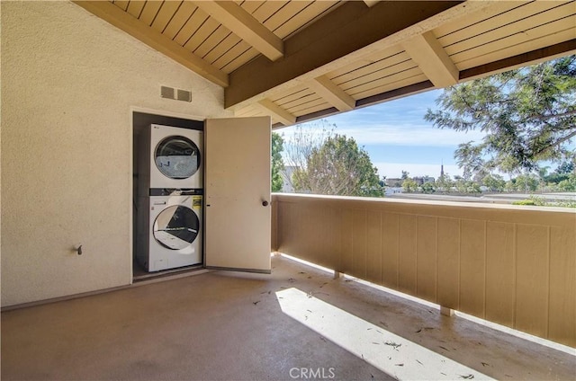 interior space featuring stacked washer / dryer