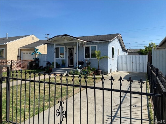 bungalow-style home with a garage and a front lawn