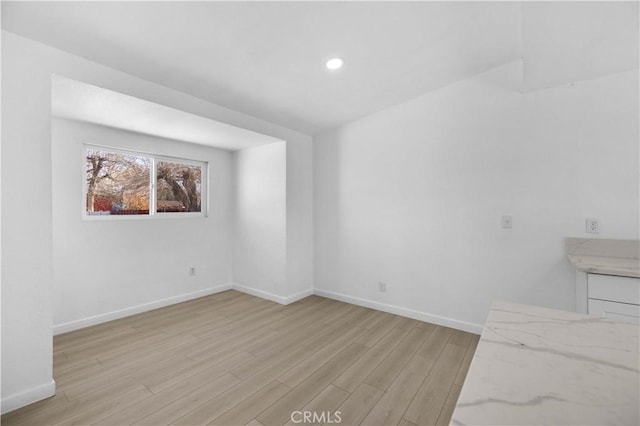 spare room featuring light hardwood / wood-style flooring