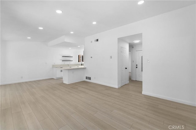 unfurnished living room featuring light wood-type flooring