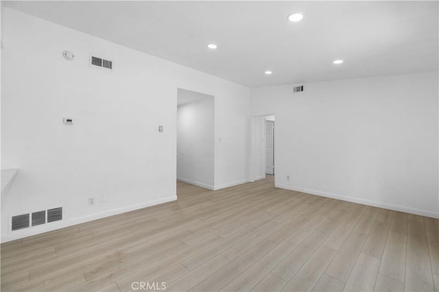 spare room featuring light hardwood / wood-style flooring