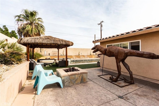 view of patio / terrace featuring a gazebo and an outdoor living space with a fire pit