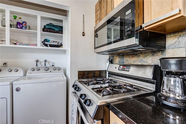 kitchen featuring backsplash, separate washer and dryer, and appliances with stainless steel finishes