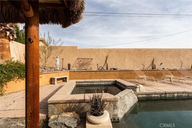 exterior space with a pool with hot tub