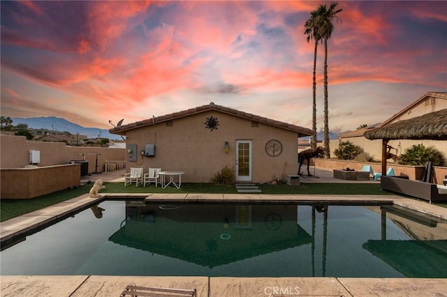 pool at dusk with a mountain view