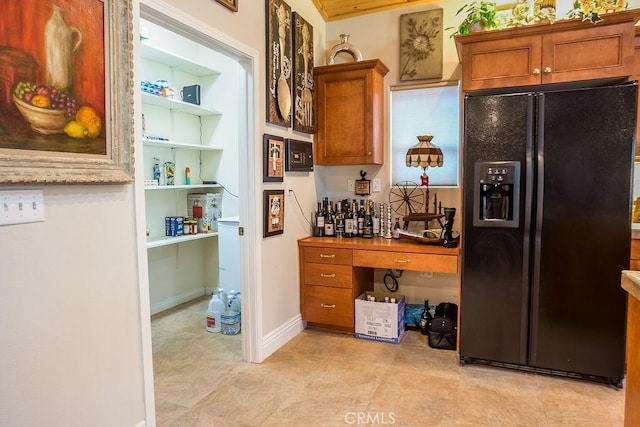 kitchen featuring black refrigerator with ice dispenser