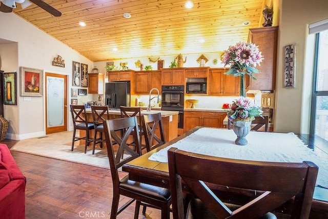 dining space featuring hardwood / wood-style flooring, ceiling fan, lofted ceiling, and wood ceiling