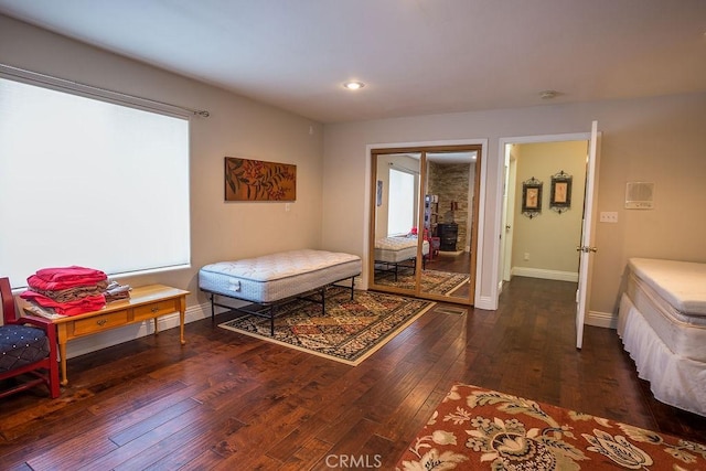 bedroom with dark hardwood / wood-style floors