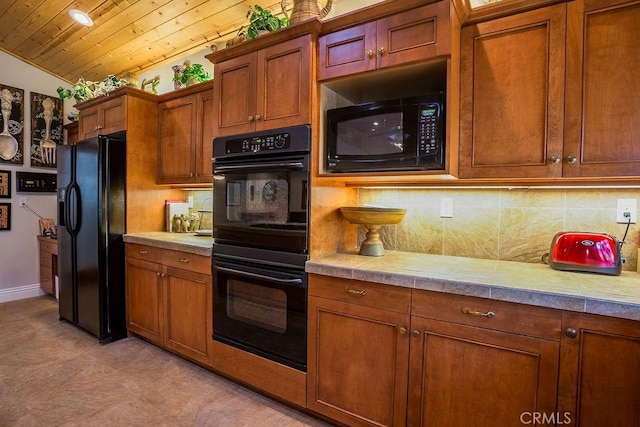 kitchen with tasteful backsplash, tile countertops, lofted ceiling, black appliances, and wood ceiling