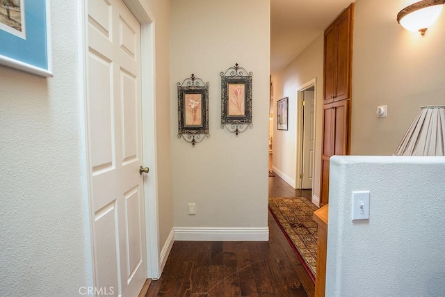 corridor with dark hardwood / wood-style floors