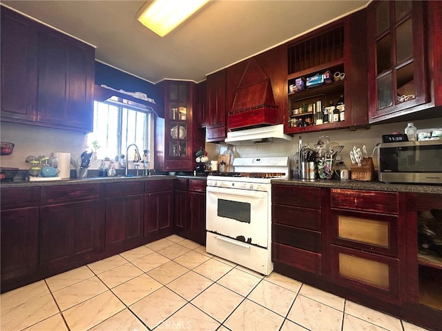 kitchen with sink, light tile patterned floors, white gas range, and custom range hood