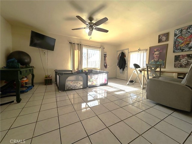 living room featuring ceiling fan and light tile patterned floors