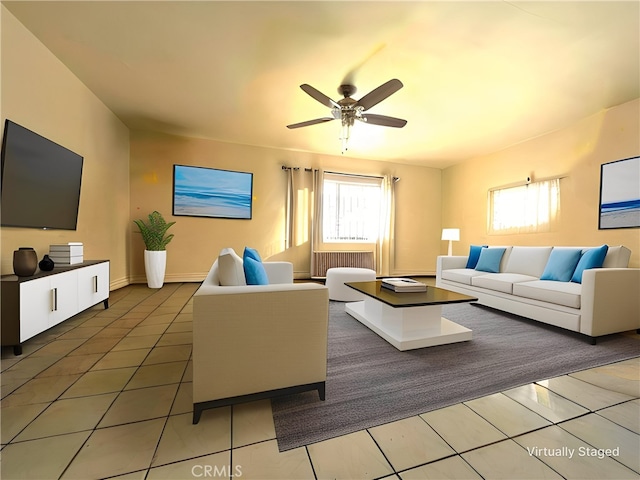 living room featuring ceiling fan, radiator, and tile patterned floors