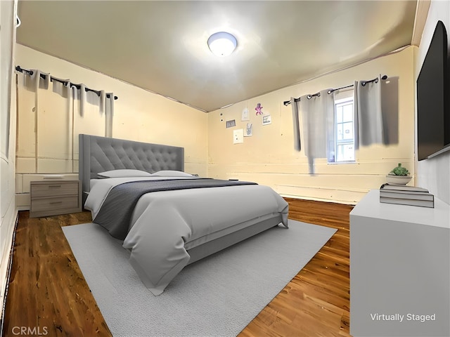 bedroom with dark wood-type flooring