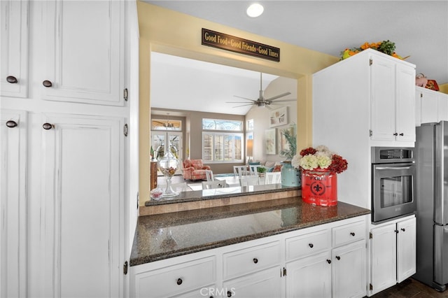 kitchen featuring white cabinetry, dark stone countertops, ceiling fan, and appliances with stainless steel finishes