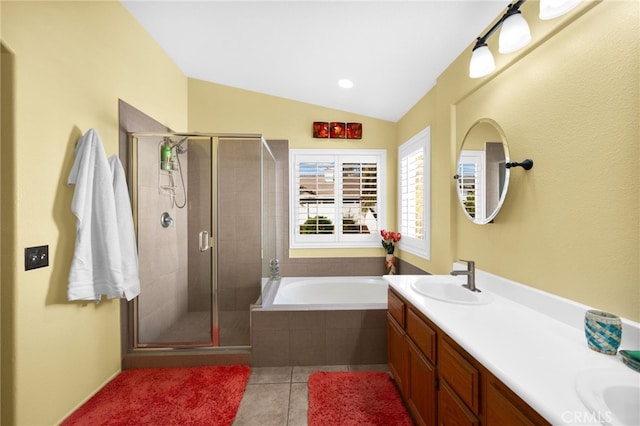 bathroom with plus walk in shower, vanity, lofted ceiling, and tile patterned floors