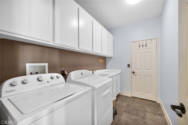 washroom featuring cabinets, separate washer and dryer, and sink