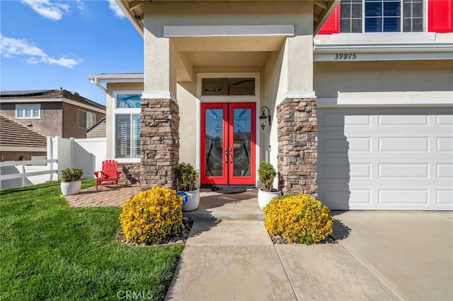 doorway to property with french doors and a garage