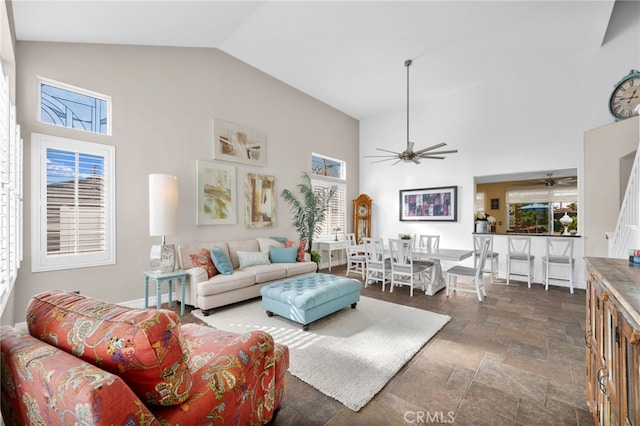 living room with high vaulted ceiling, ceiling fan, and a wealth of natural light