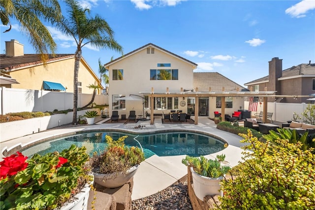 rear view of house with a fenced in pool, a patio area, and outdoor lounge area