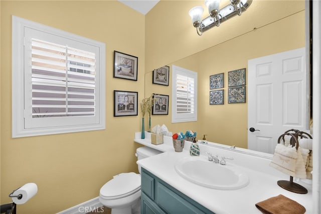 bathroom featuring toilet and vanity