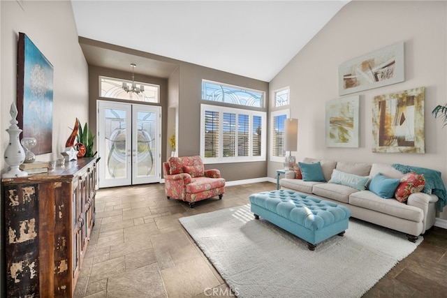 living room featuring high vaulted ceiling and an inviting chandelier