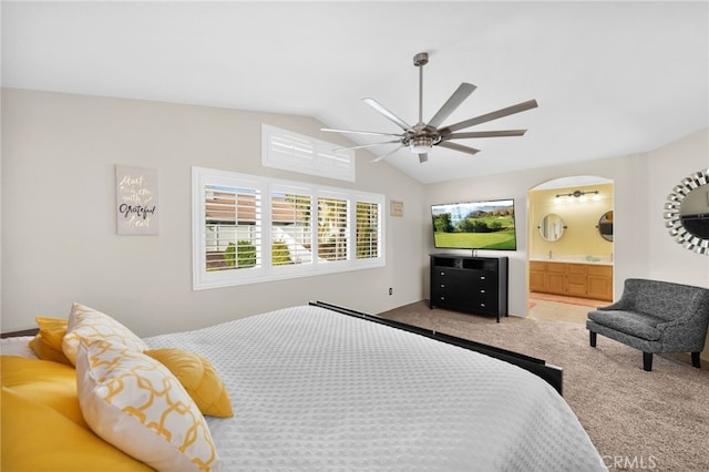 carpeted bedroom with ceiling fan, ensuite bathroom, and lofted ceiling