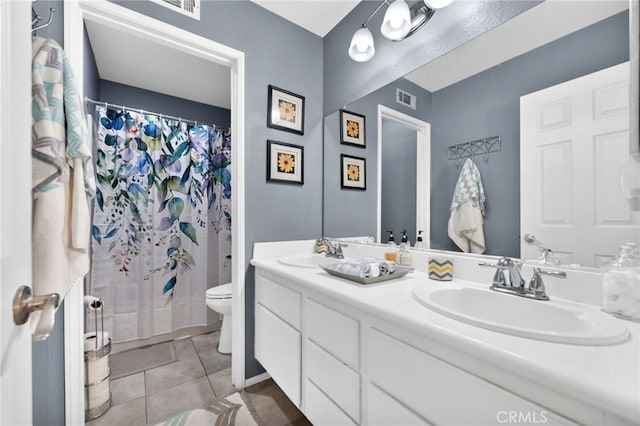 bathroom with toilet, tile patterned floors, walk in shower, and vanity