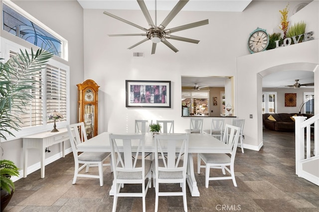 dining space with a towering ceiling