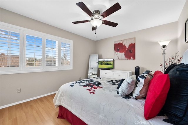 bedroom with ceiling fan and light hardwood / wood-style floors