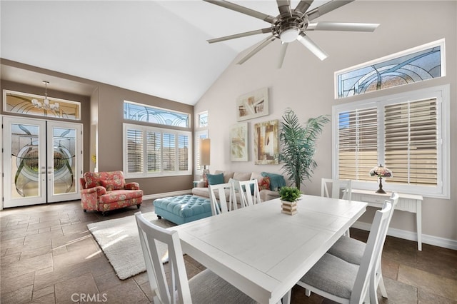 dining area featuring ceiling fan with notable chandelier and lofted ceiling