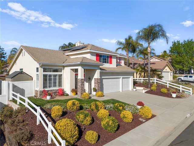 view of front of home with solar panels and a garage