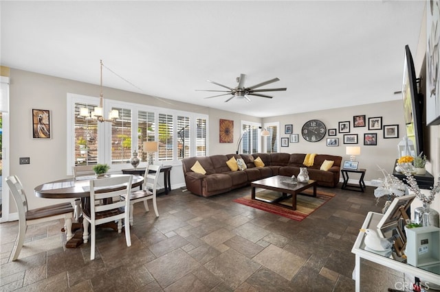 living room featuring ceiling fan with notable chandelier