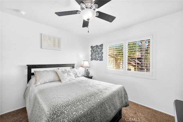 bedroom with ceiling fan and dark colored carpet